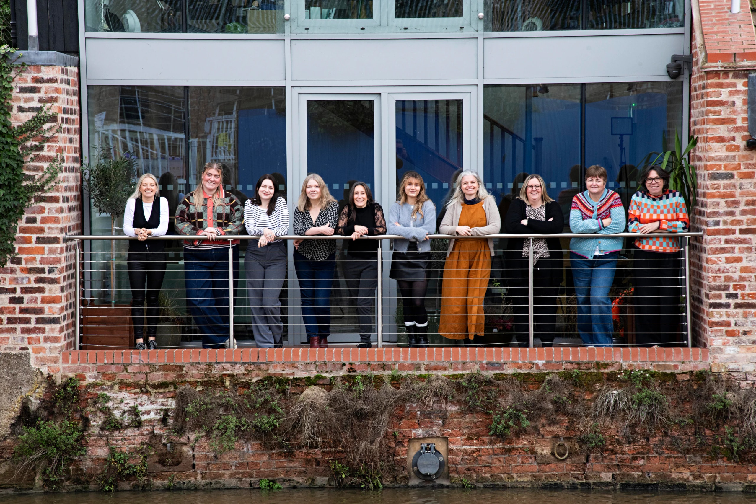 The Influence team together on the balcony of the Newark studio