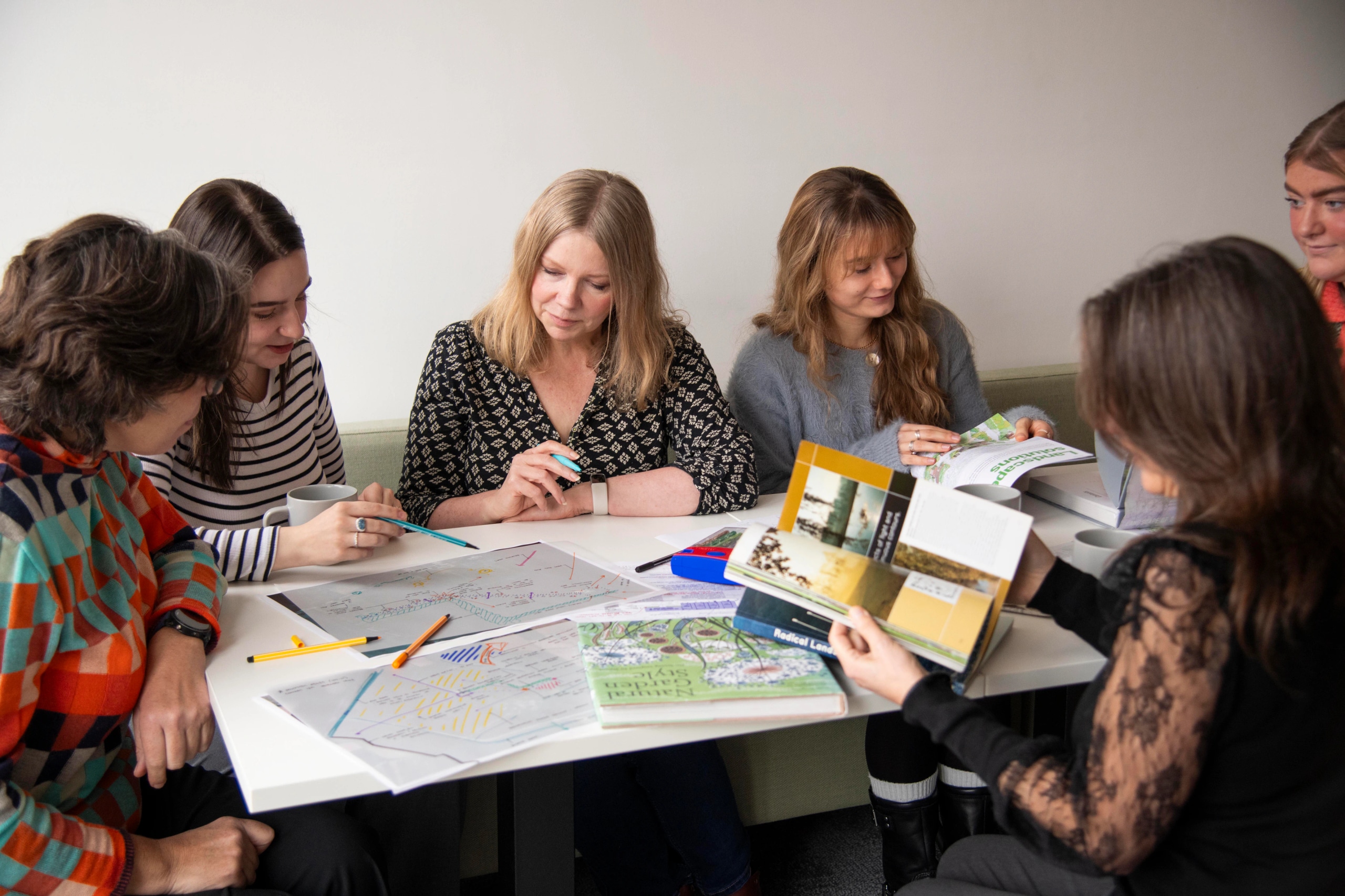 Influence staff reviewing landscape plans together in the Newark studio
